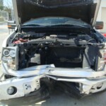 Before and after photographs of a damaged Ford pickup truck that was repaired by Elite Paint & Body Shop in West Palm Beach, Florida.